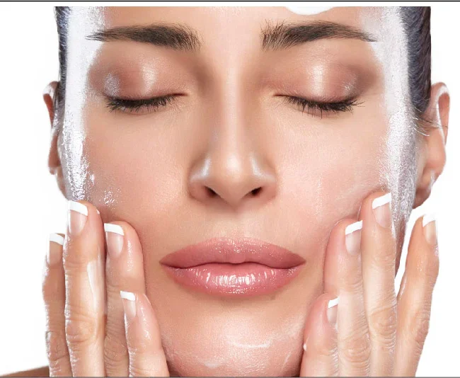 Woman washing face with gentle cleanser as part of daily skincare routine