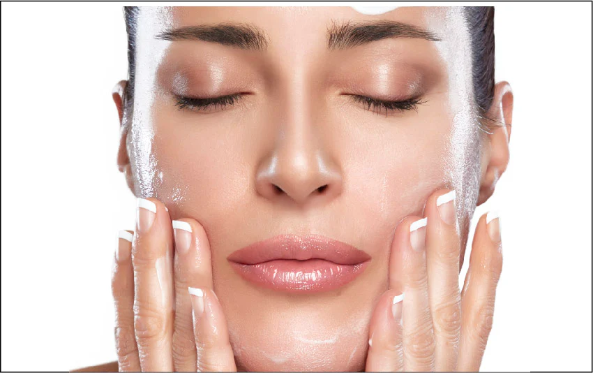 Woman washing face with gentle cleanser as part of daily skincare routine